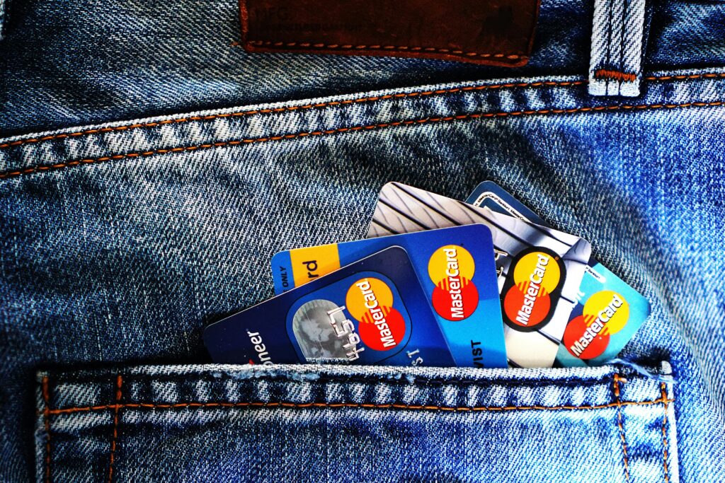 Close-up of a denim pocket with multiple credit cards, illustrating finance and fashion.